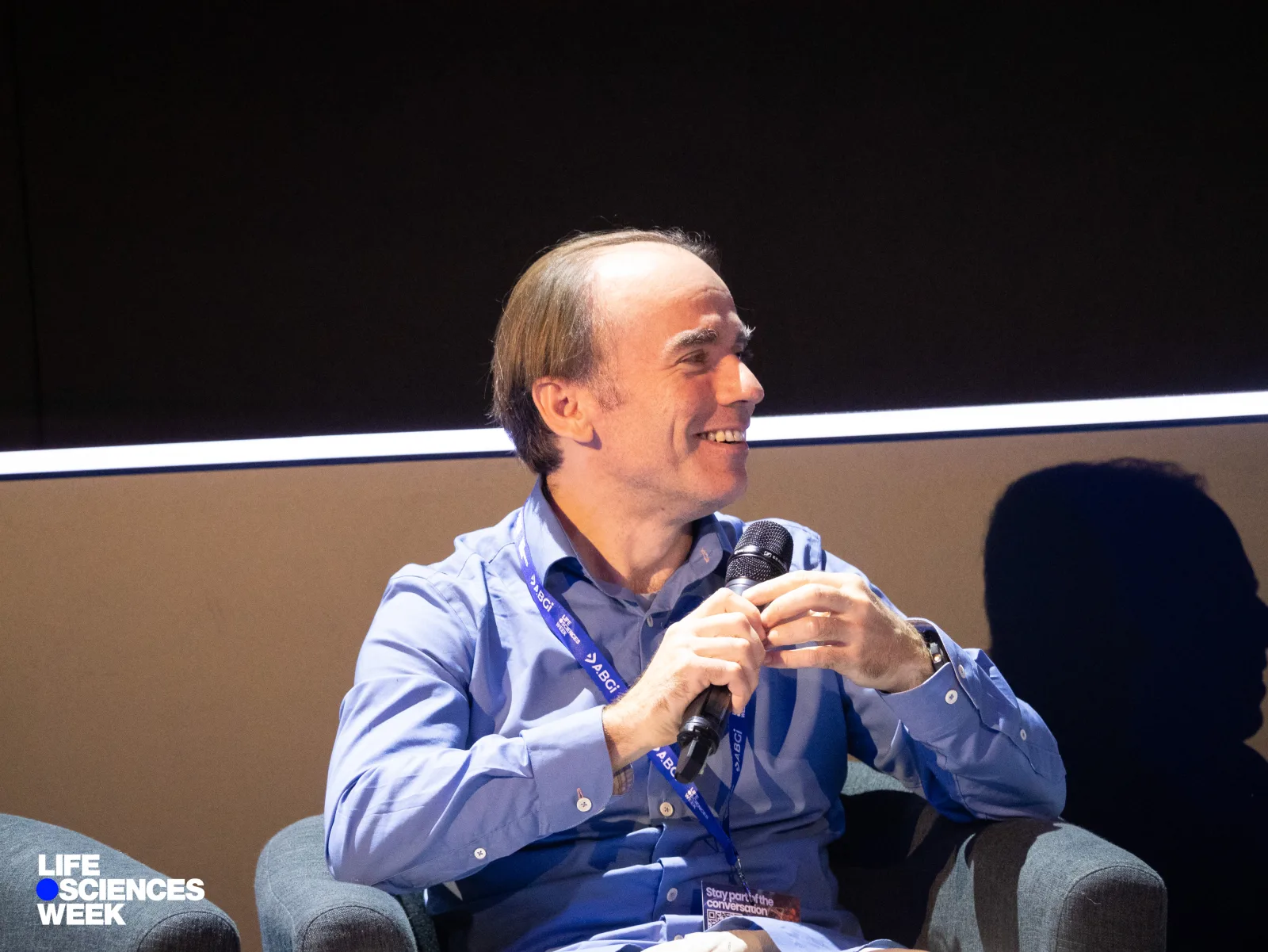 Vid Stojevic holding a microphone during the Life Sciences Week panel.